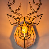 A geometric deer head wall art is attached to an eight-sided marble shape and hung on the wall