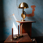 Stainless steel candleholder set on a wooden table