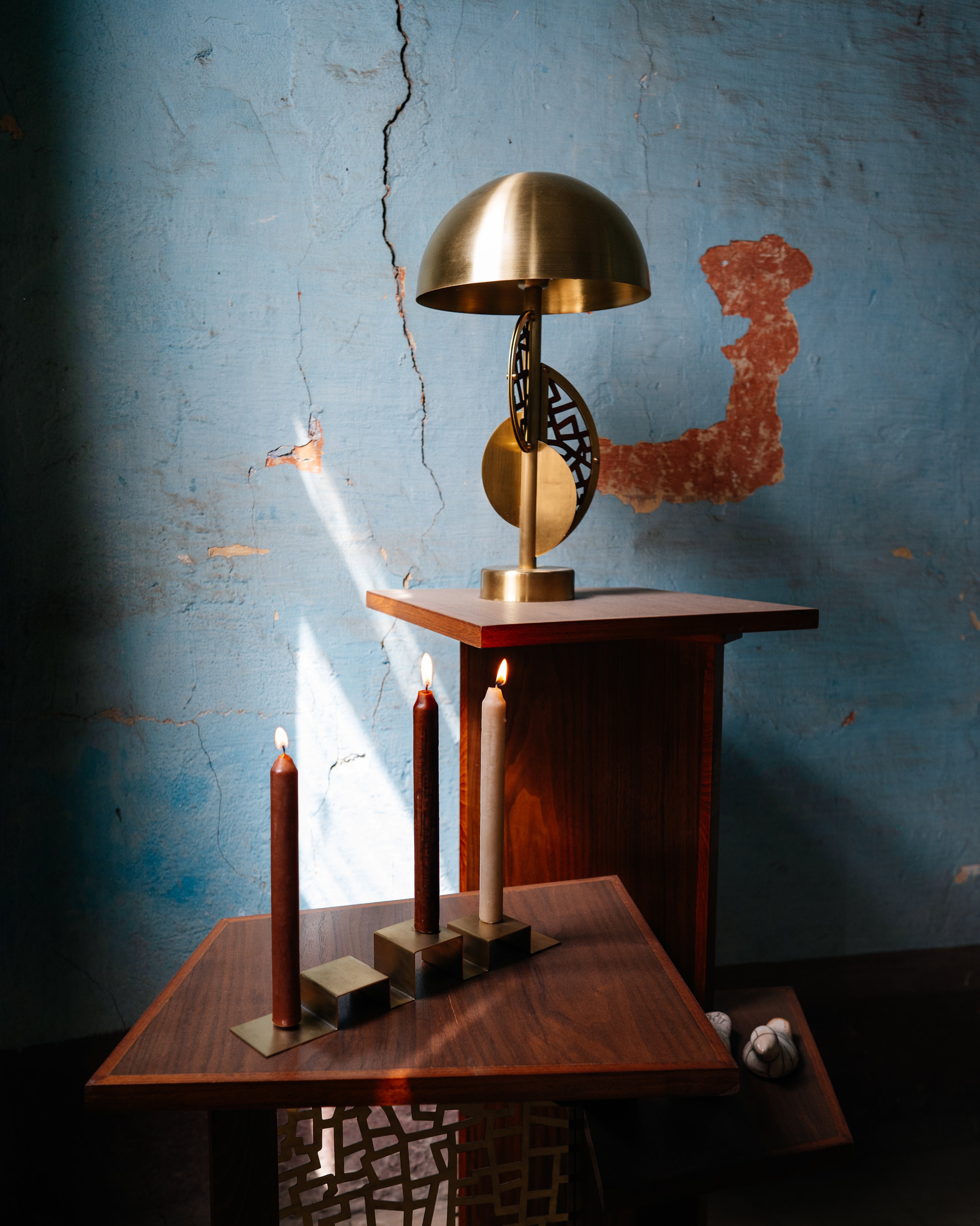 Stainless steel candleholder set on a wooden table 
