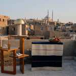 Corner wooden table with three tiers featured in a photoshoot in Egypt