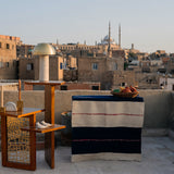 Corner wooden table with three tiers featured in a photoshoot in Egypt