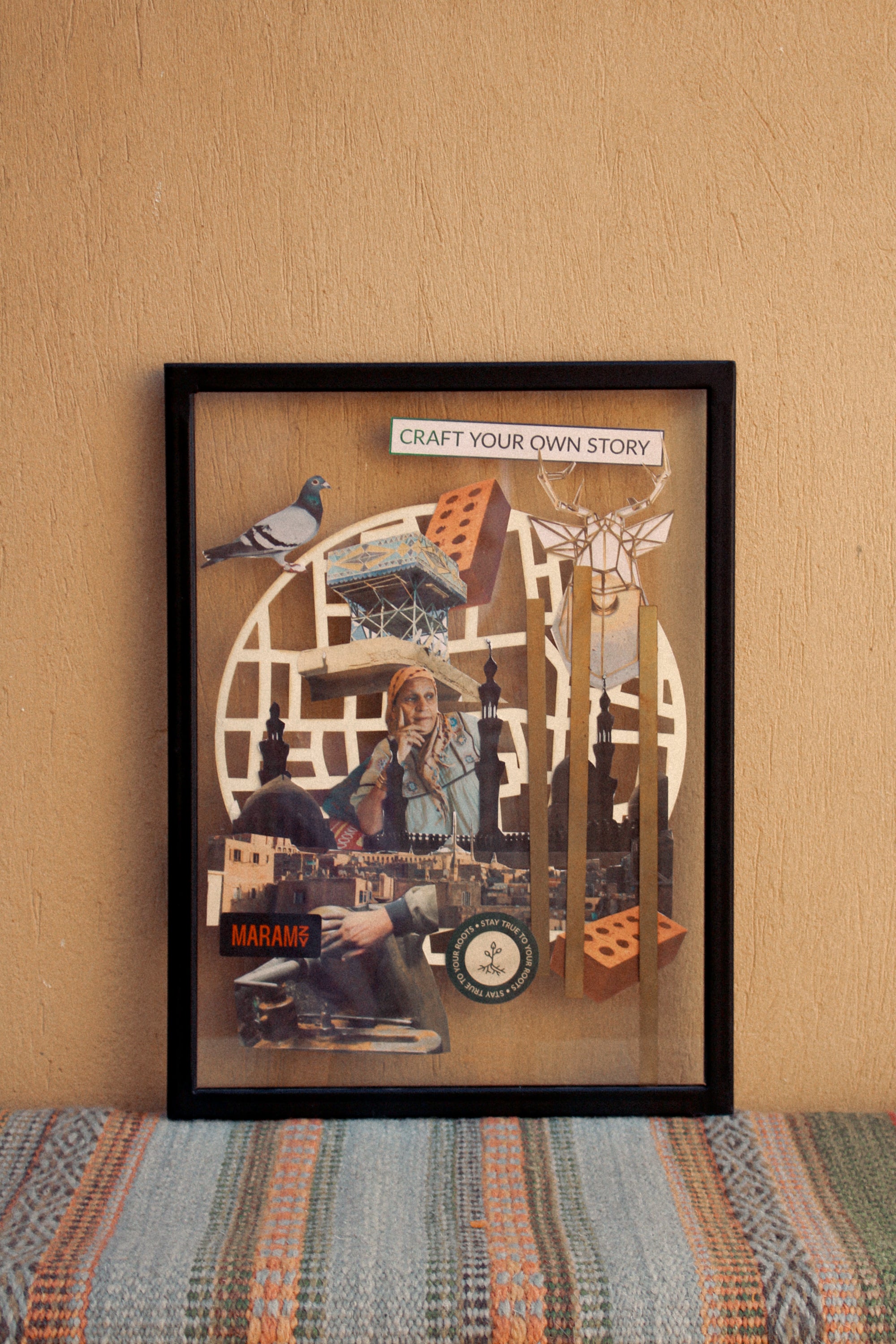 A collage is inserted into the black wooden photo frame and hung on the wall.