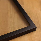 A detailed look at the side of the black wooden photo frame