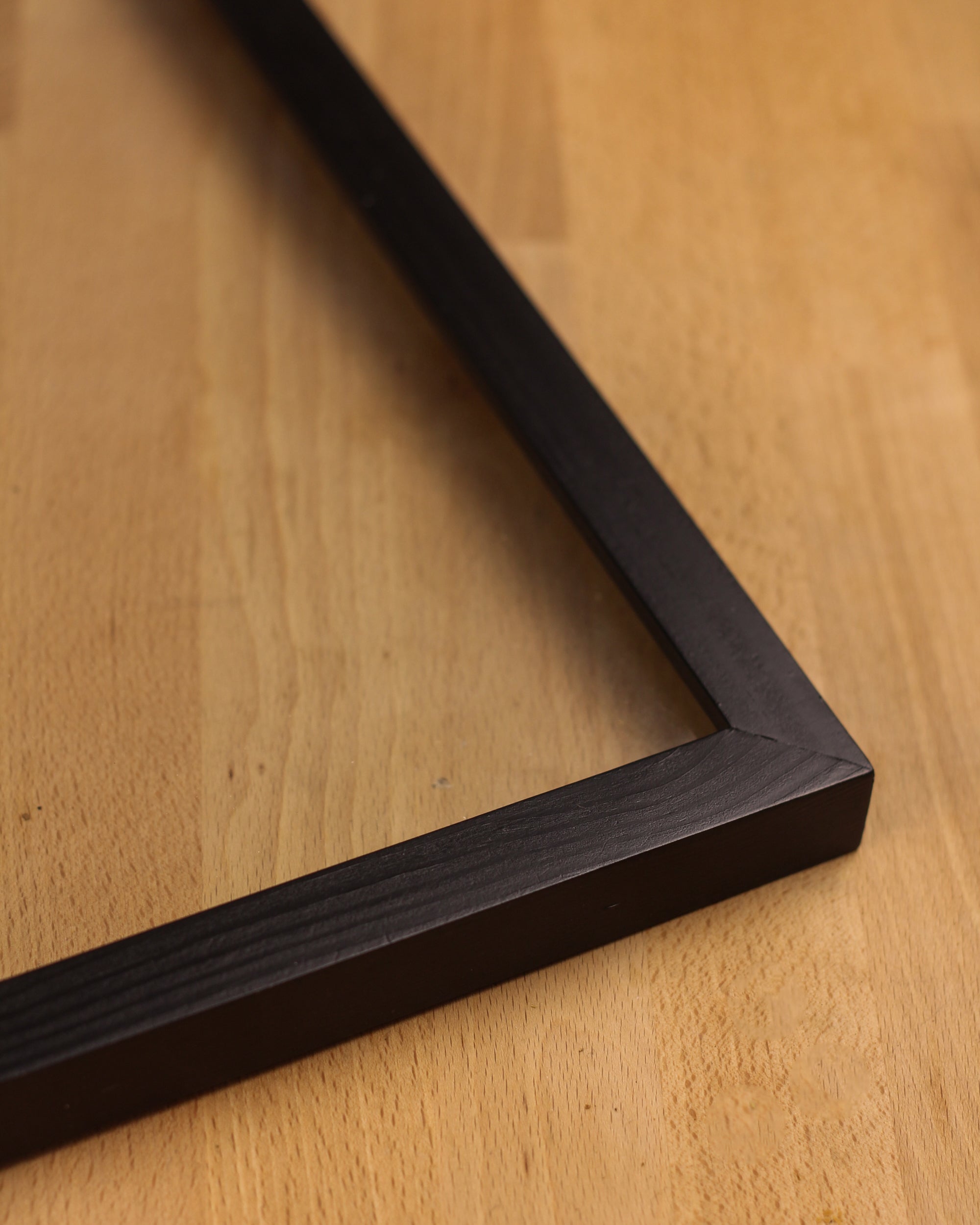 A detailed look at the side of the black wooden photo frame