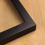 A detailed look at the side of the black wooden photo frame