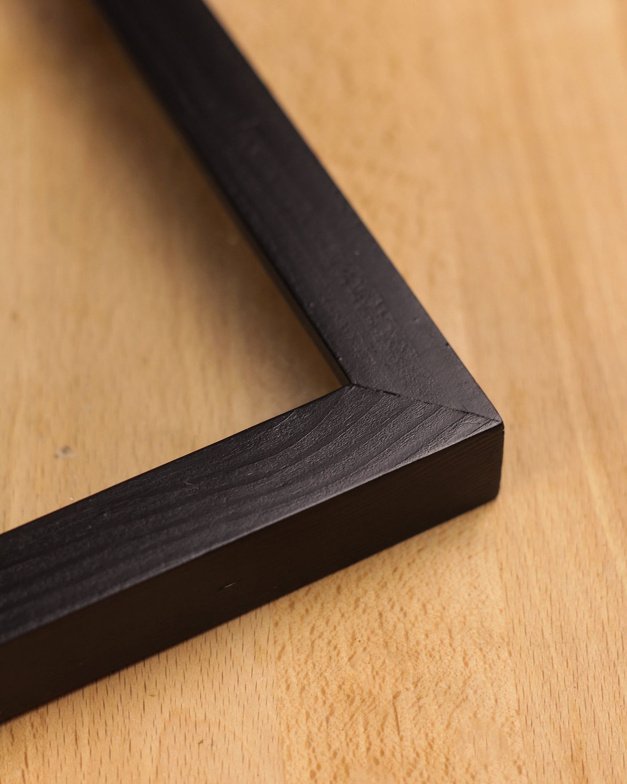 A detailed look at the side of the black wooden photo frame