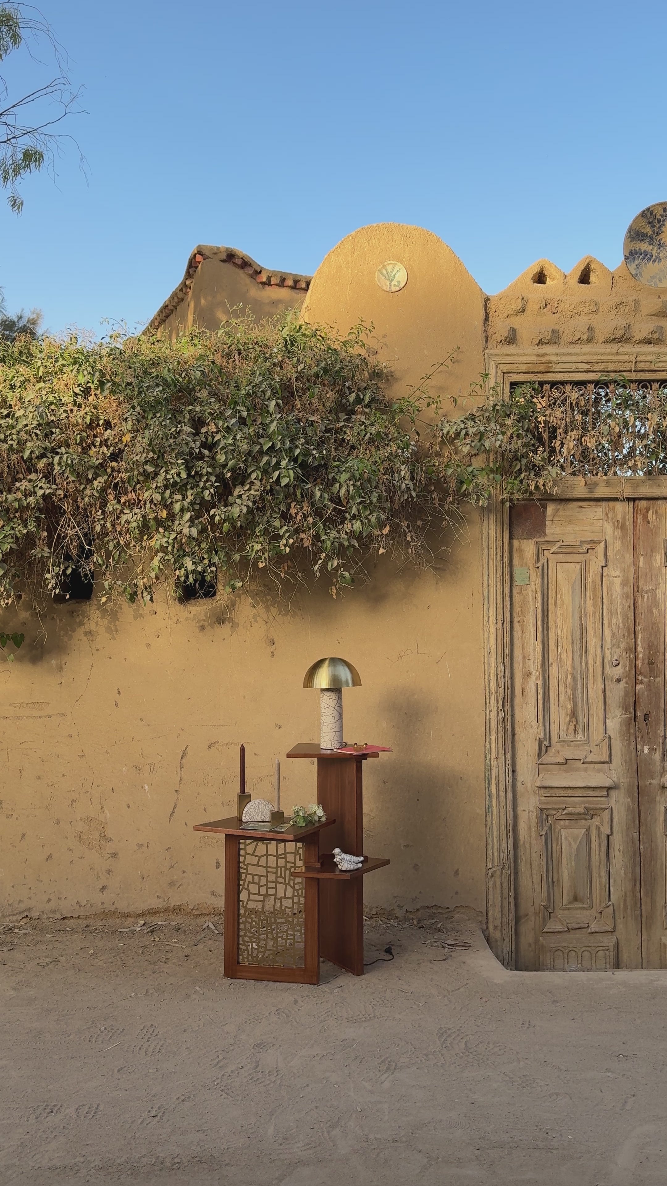 Mastaba Corner wooden table set in the middle of the street